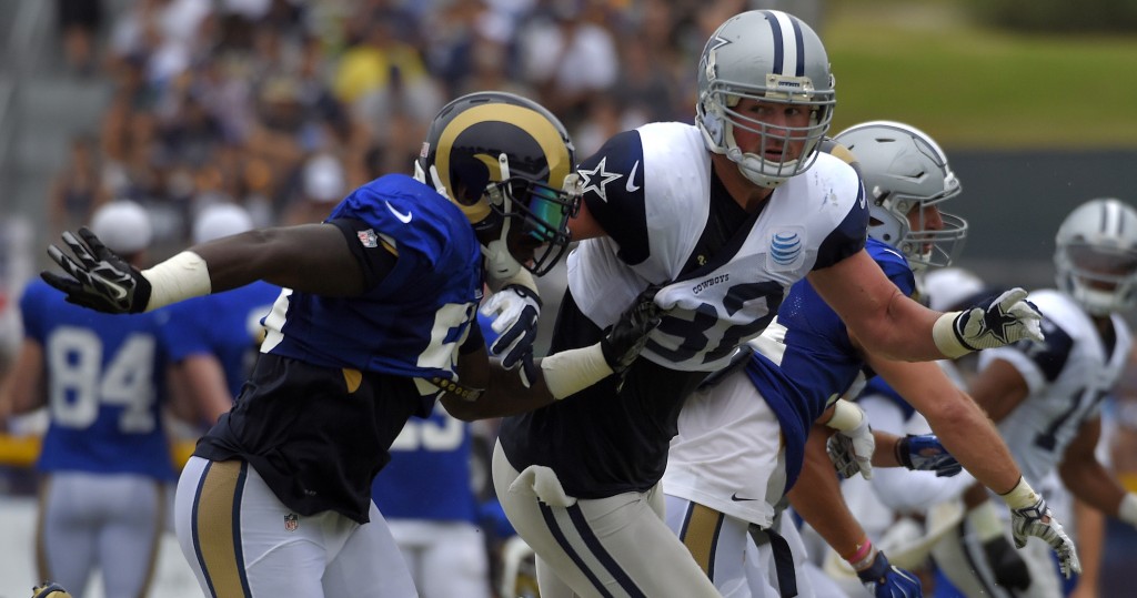 Dallas Cowboys tight end Jason Witten, right, battles St. Louis Rams outside linebacker Jo-Lonn Dunbar during a joint NFL football training camp, Monday, Aug. 17, 2015, in Oxnard, Calif. (AP Photo/Mark J. Terrill)