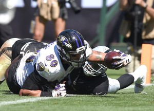 OAKLAND, CA - SEPTEMBER 20: Crockett Gillmore #80 of the Baltimore Ravens breaks the plane for a touchdown in the second quarter against the Oakland Raiders at Oakland-Alameda County Coliseum on September 20, 2015 in Oakland, California. (Photo by Thearon W. Henderson/Getty Images)
