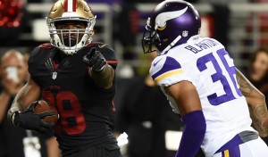 SANTA CLARA, CA - SEPTEMBER 14: Carlos Hyde #28 of the San Francisco 49ers points at Robert Blanton #36 of the Minnesota Vikings as he runs for a touchdown during their NFL game at Levi