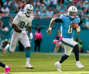 Tennessee Titans quarterback Marcus Mariota (8) outruns Miami Dolphins defensive end Mario Williams (94) for a long gain during the second half at Hard Rock Stadium on October 9, 2016.  (Richard Graulich / The Palm Beach Post)